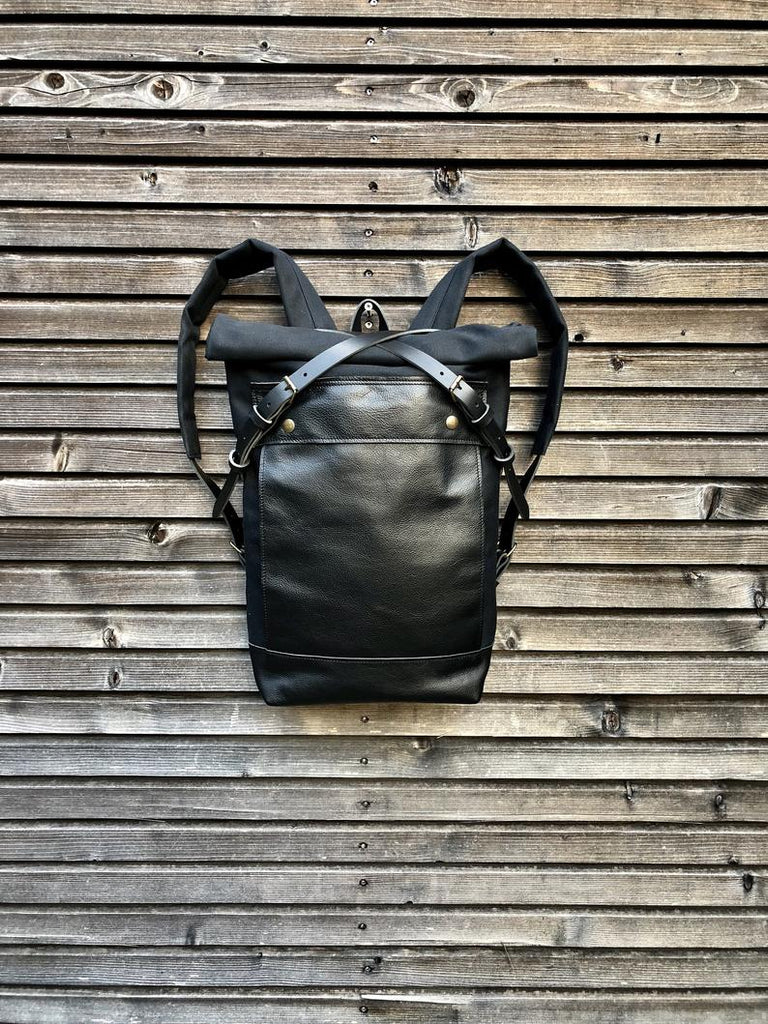 Black backpack medium size rucksack in waxed canvas, with leather front pocket and bottom
