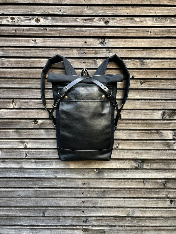 Black backpack medium size rucksack in waxed canvas, with leather front pocket and bottom